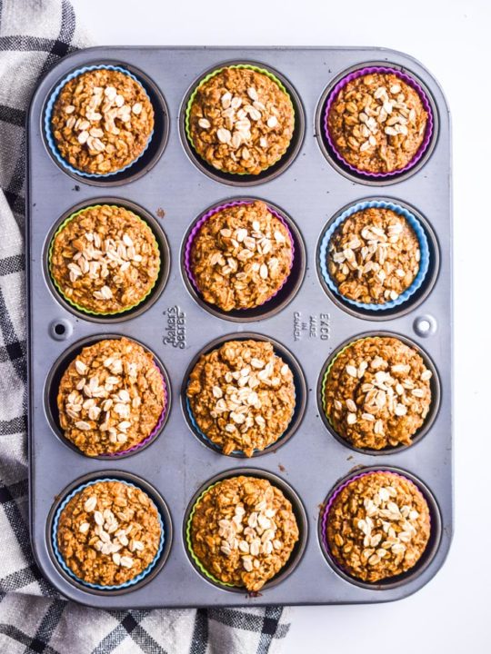banana oatmeal muffins in a muffin pan with colored silicone muffin cups