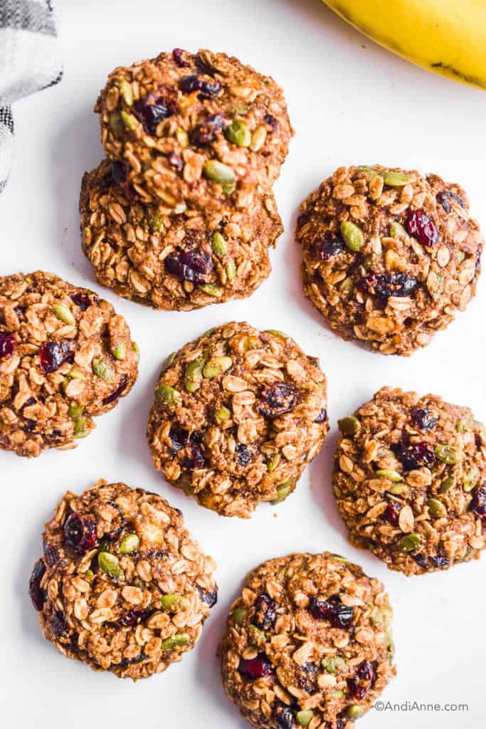 banana cranberry breakfast cookies on white table with bananas in top right corner