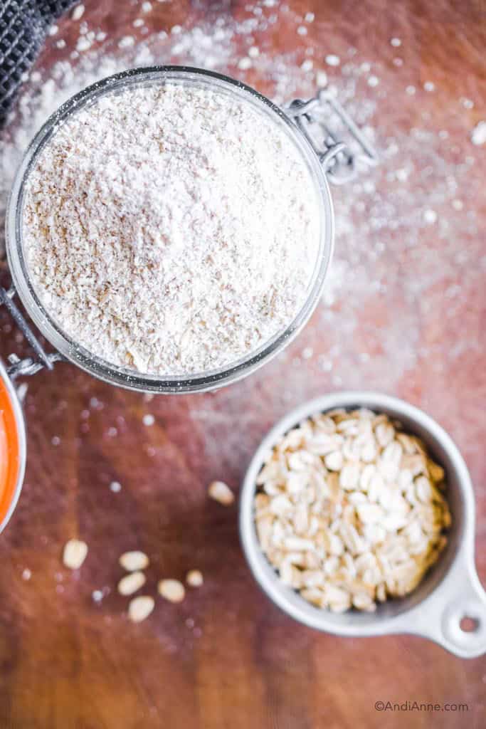 homemade oat flour in a jar with rolled oats in a small cup