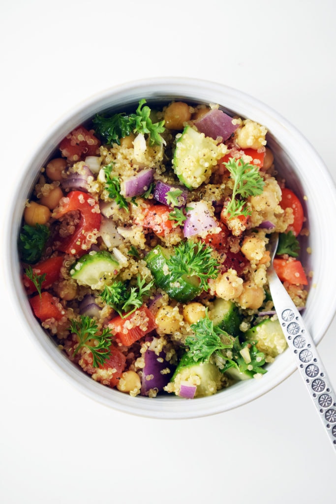 honey dijon quinoa salad close up detail in white bowl with decorative fork