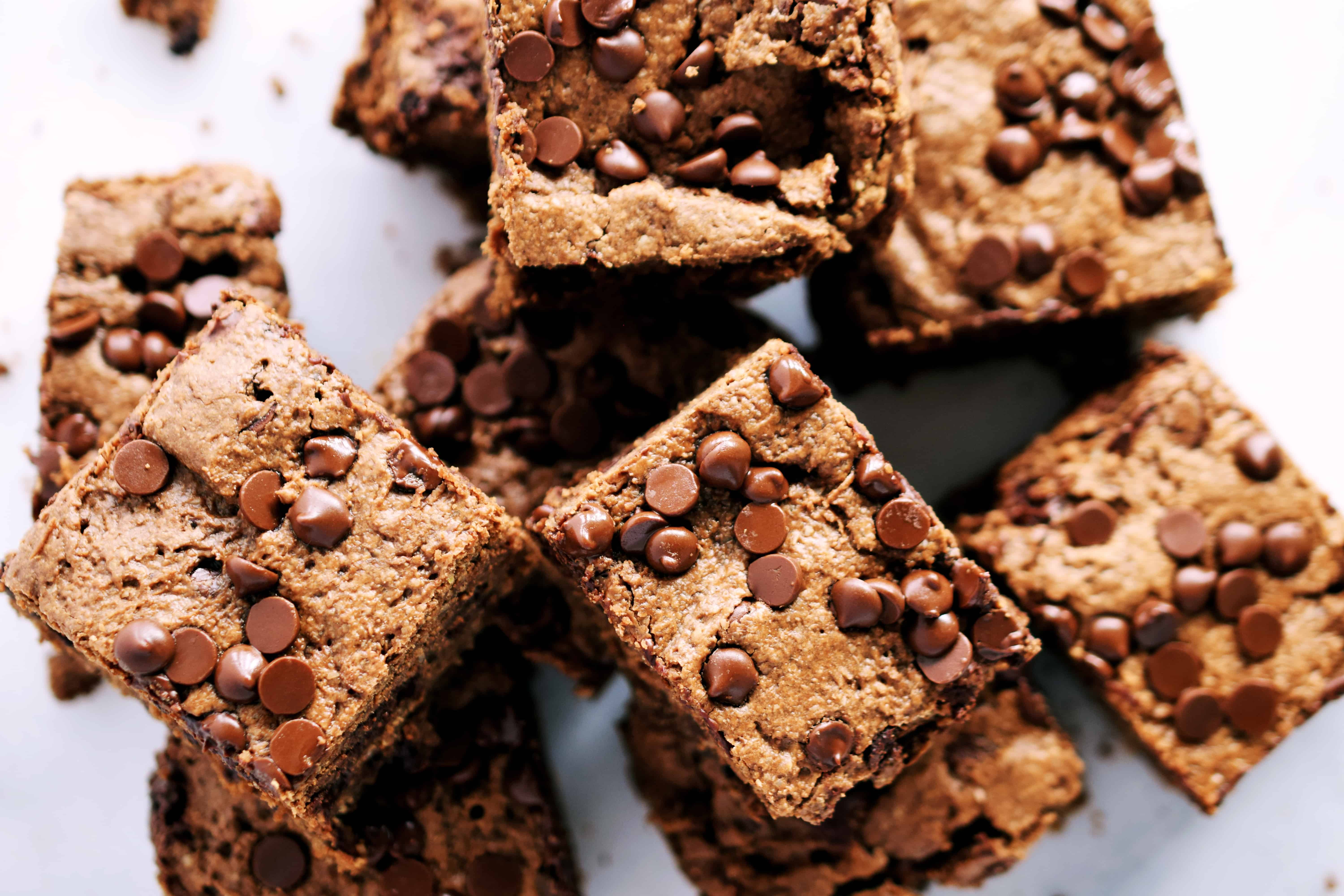 nut butter oat brownies in squares stacked on eachother