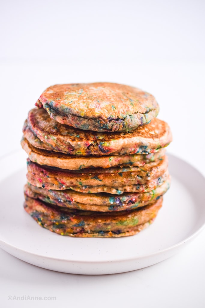 stack of sprinkle pancakes on a white plate