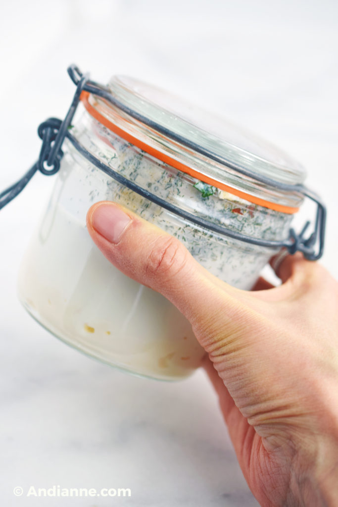 shaking ingredients in canning jar with hand