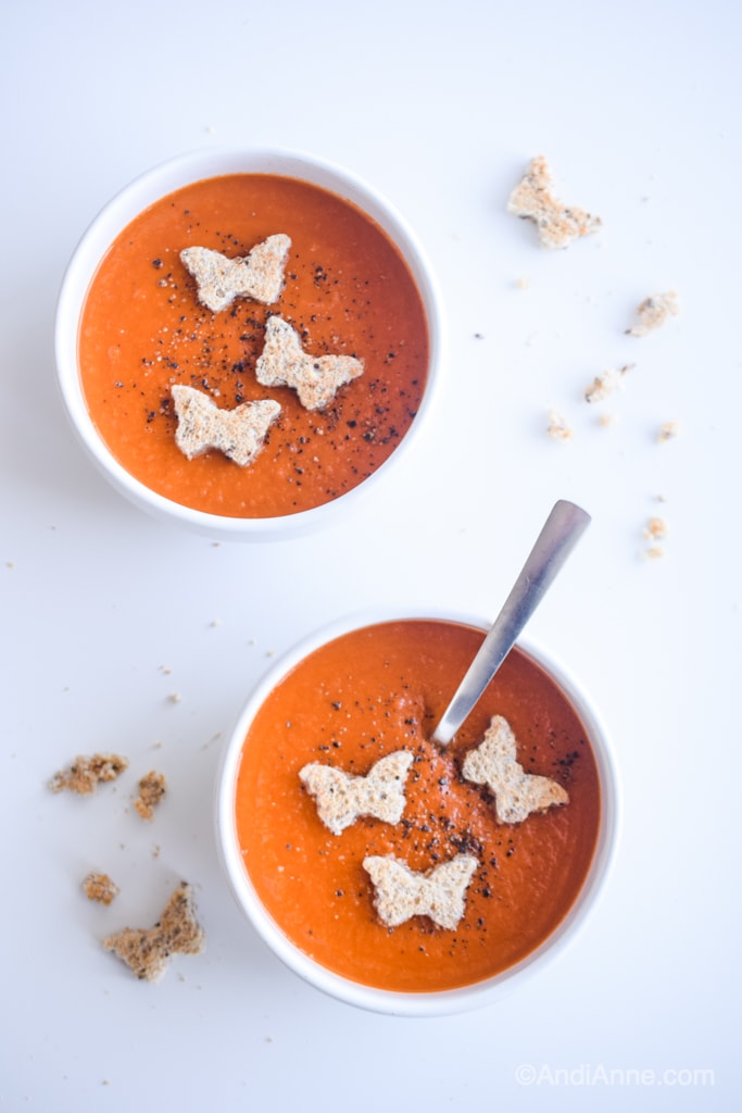 Classic homemade tomato soup with butterfly croutons in white bowls