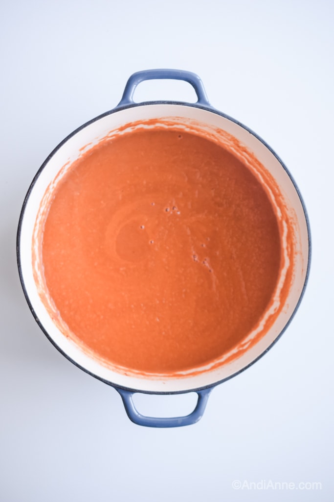 tomato soup in a large blue dutch oven pot