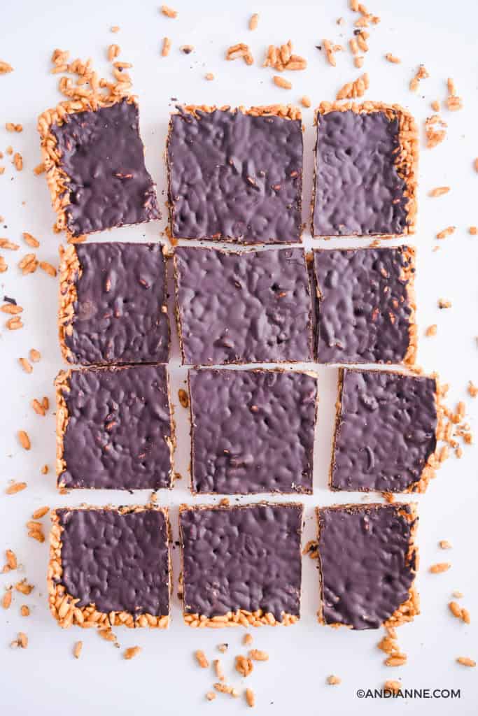 chocolate puffed rice squares cut into pieces. Rice crumbles surrounding.