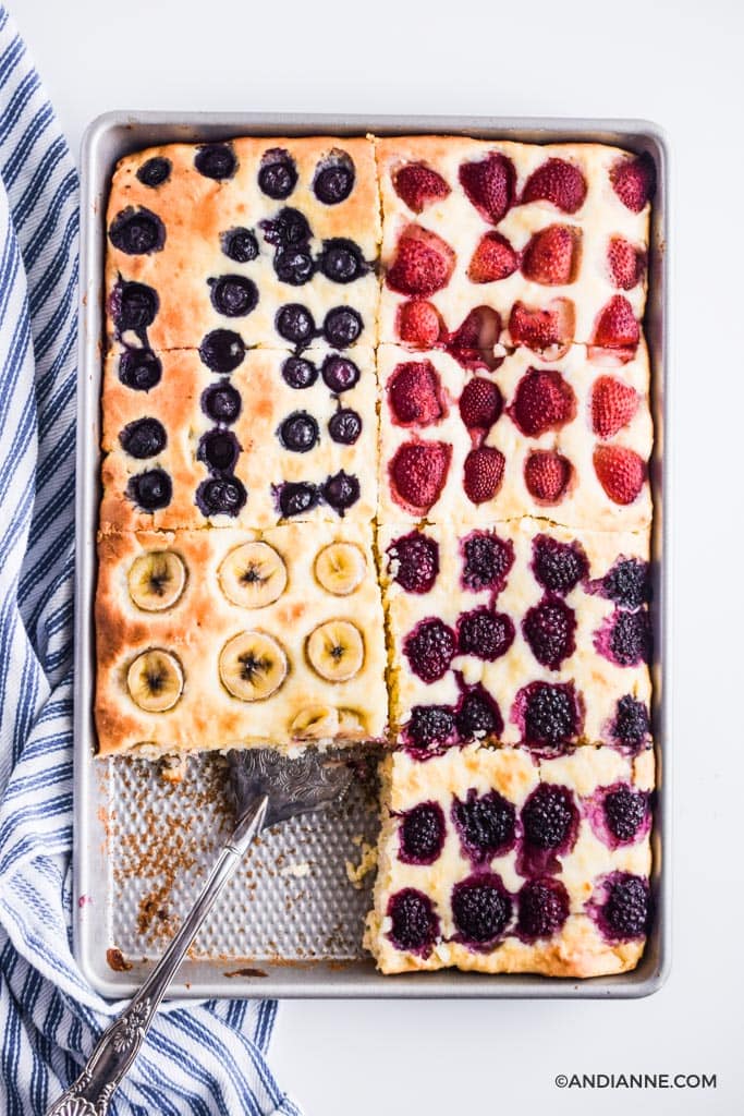 sheet pan pancakes in a baking sheet with silver spatula and blue striped napkin on side