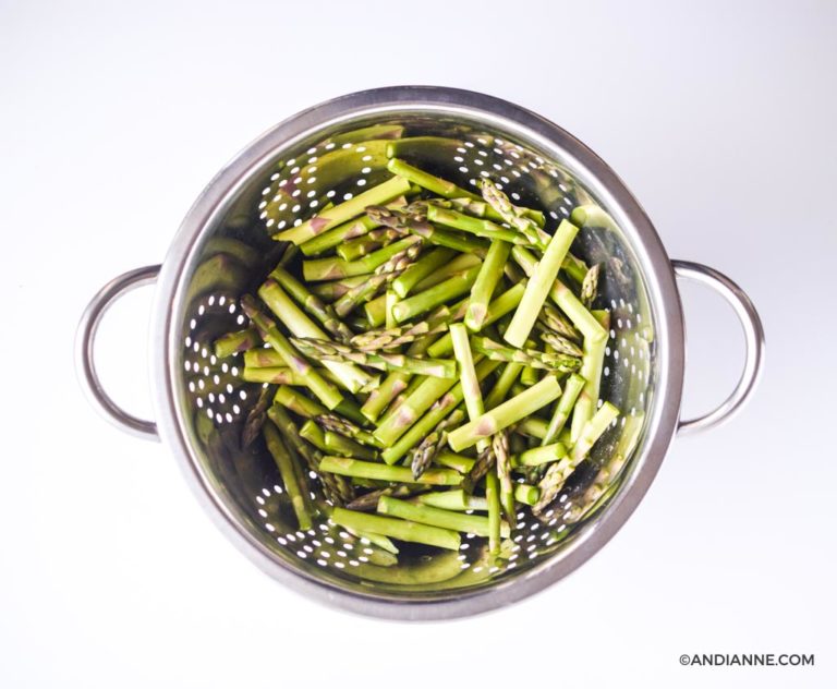 asparagus sliced into thirds in a metal strainer