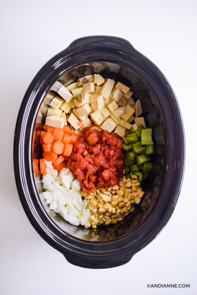 raw ingredients dumped in a black slow cooker pot