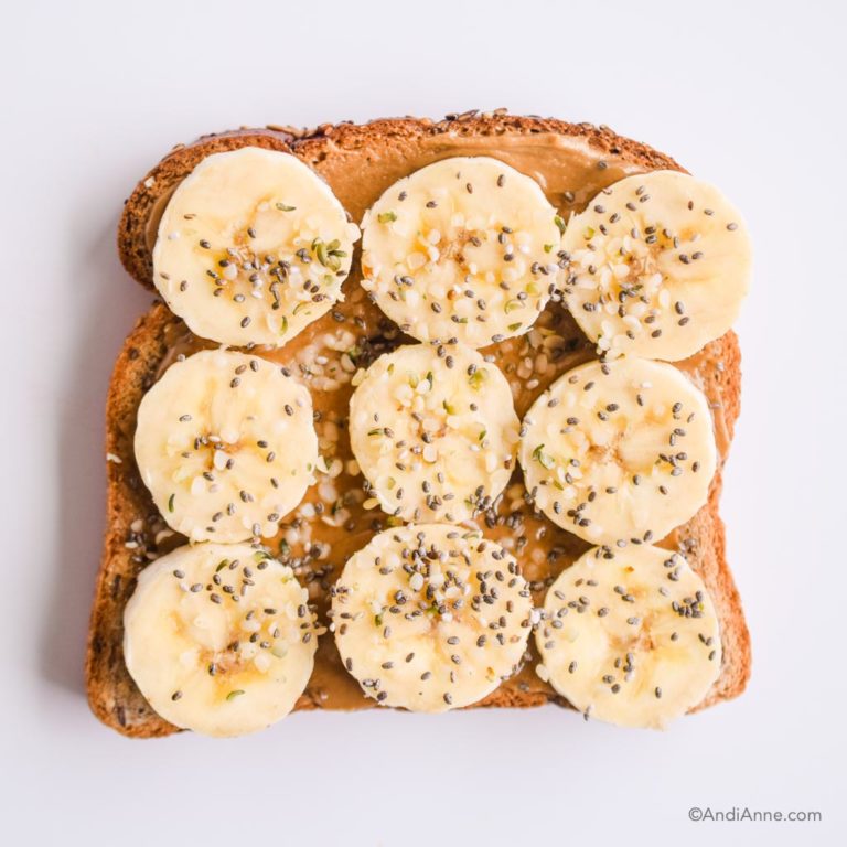 nut butter spread on toast with sliced bananas, hemp seeds and chia seeds on top