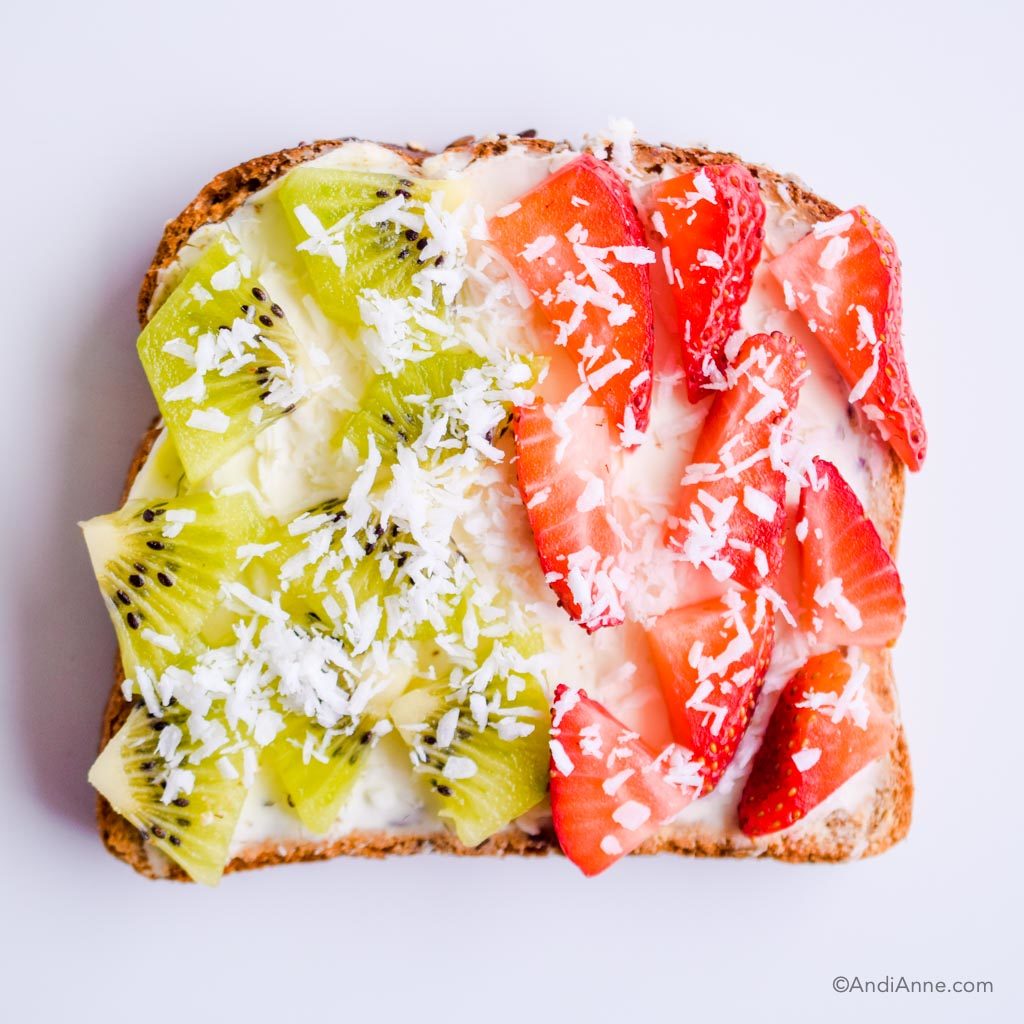 sliced kiwi and strawberries on top of cream cheese on toast. Sprinkled with shredded coconut.