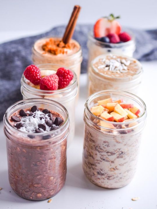 Overnight oats recipes in mason jars with topping like diced apple, chocolate chips, shredded coconut and raspberries
