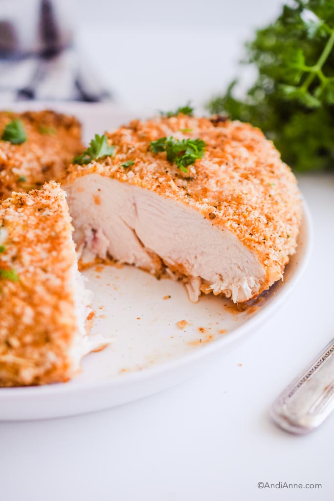 air fryer parmesan chicken breast cut open and detail of the cooked white chicken on the inside