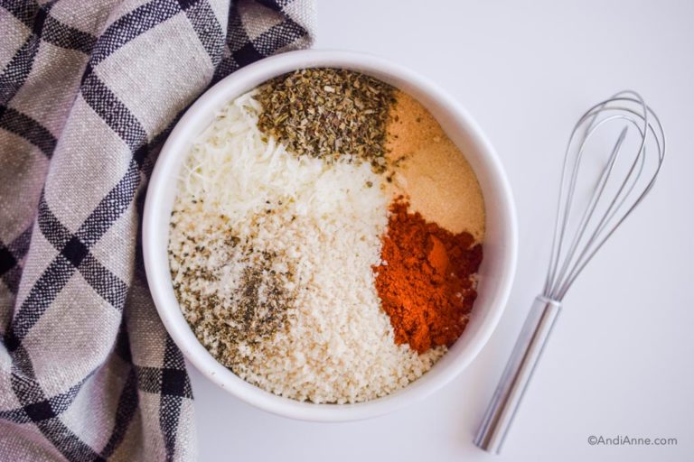spices in a white bowl with for beside it