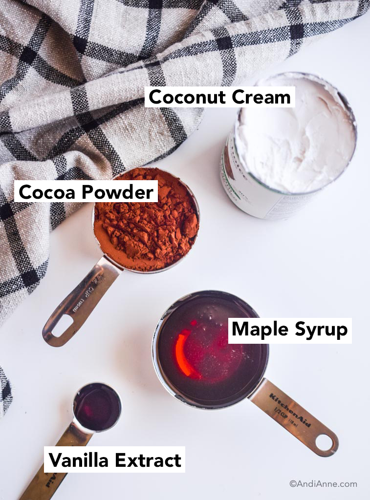 ingredients for homemade fudgesicles - canned coconut cream, cocoa powder, maple syrup and vanilla extract