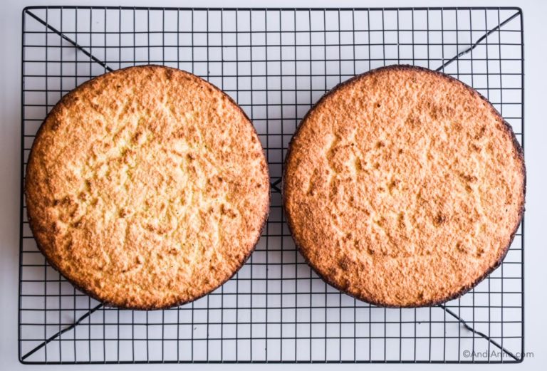two cooked cakes on a cooling rack