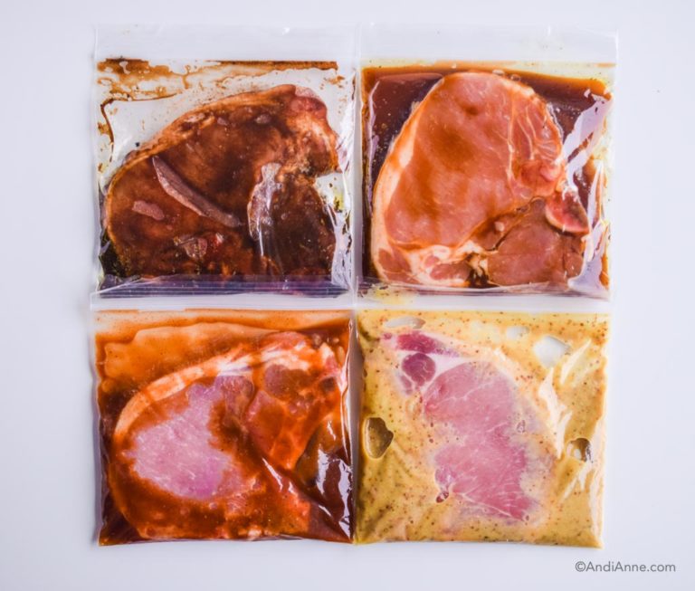 four pork chops marinating in separate plastic bags
