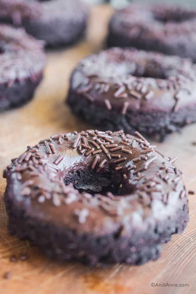 close up detail of baked chocolate donuts and sprinkles