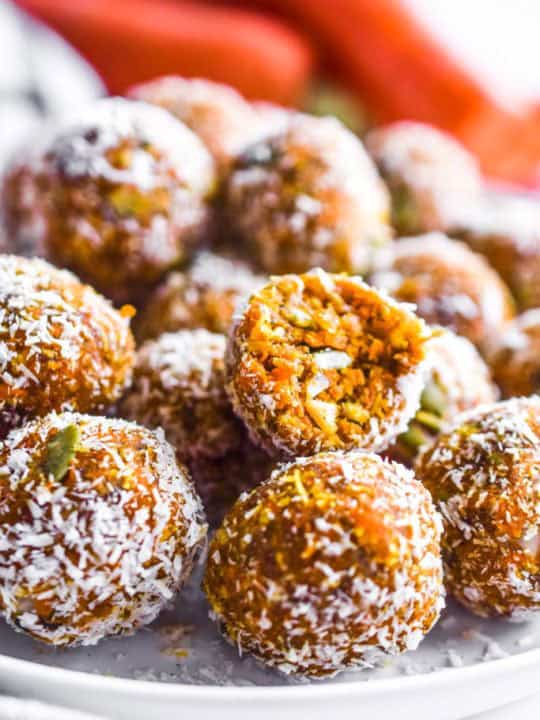 carrot cake energy bites piled on a plate close up detail.
