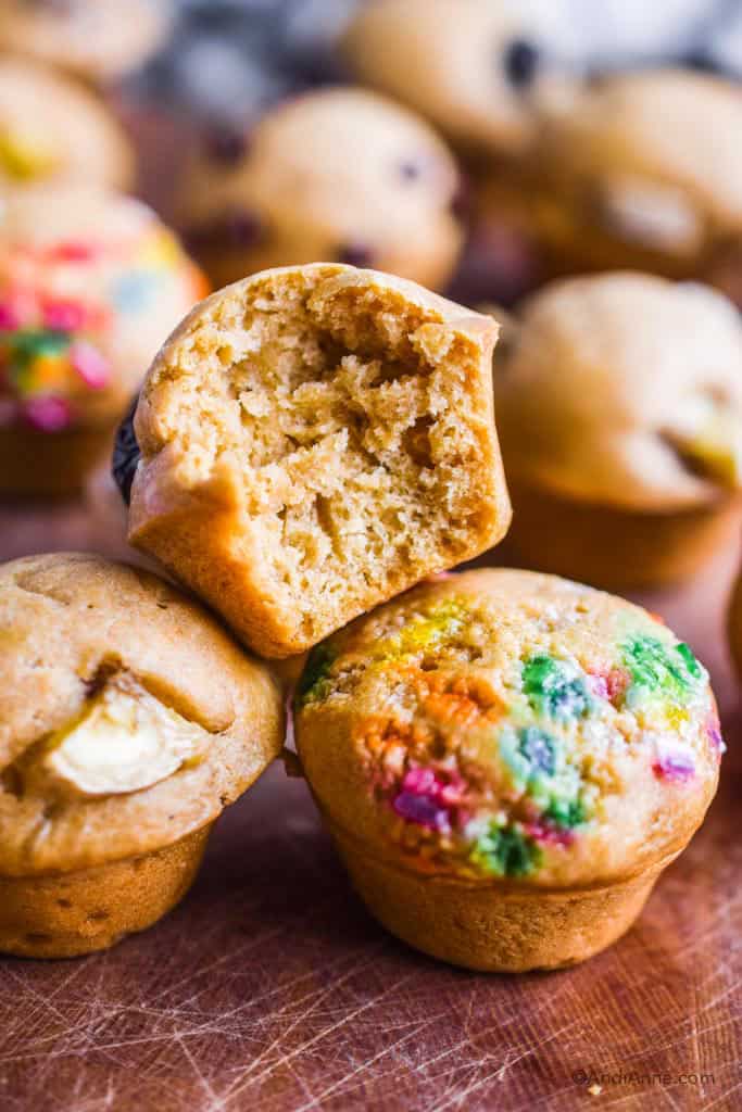 bite taken out of one mini muffin stacked on top of other muffins