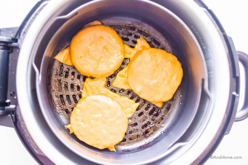 burgers with melted cheese in an air fryer