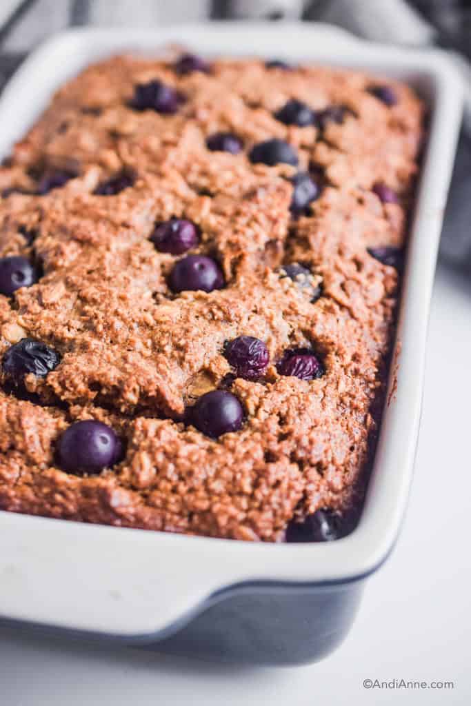 blueberry breakfast loaf in a ceramic loaf pan.