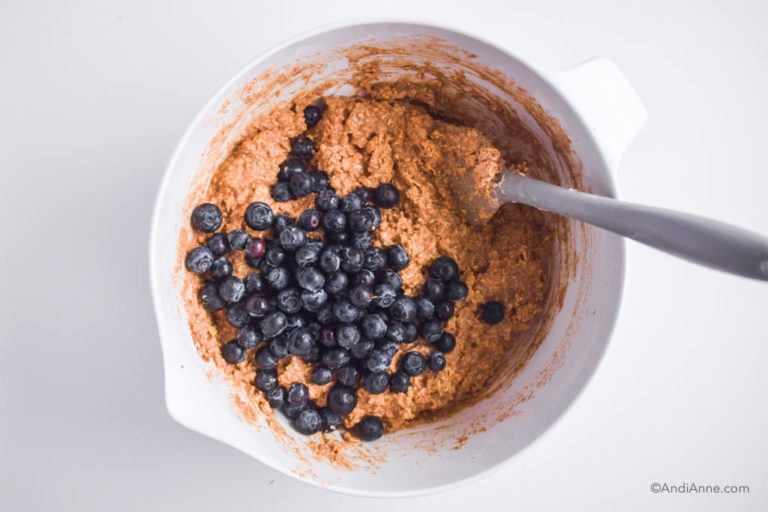 oat batter and blueberries in white mixing bowl with grey spatula