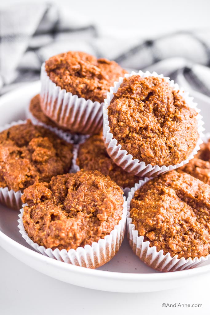 A pile of breakfast flaxseed muffins in a white bowl.