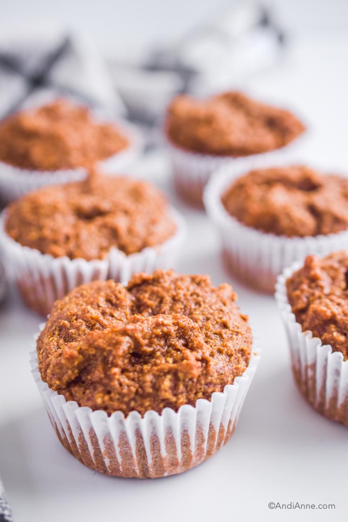 a pile of flaxseed muffins on a white counter.
