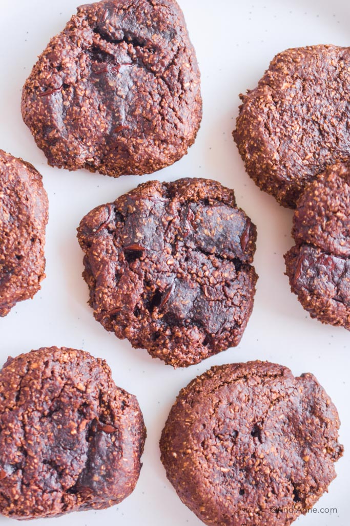 close up of a bunch of chocolate avocado cookies on a white table