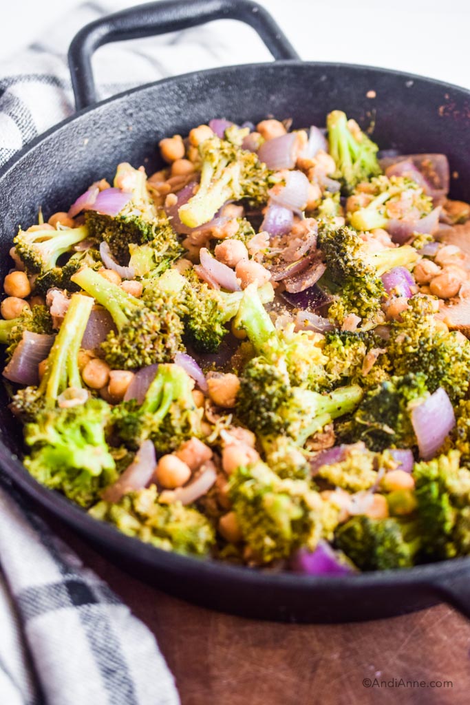 close up detail of broccoli chickpea stir fry in a frying pan 
