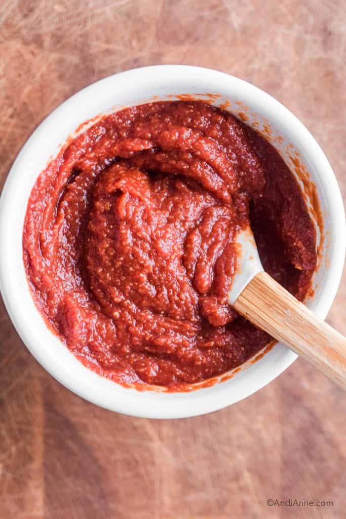keto barbecue sauce in a white bowl with spatula