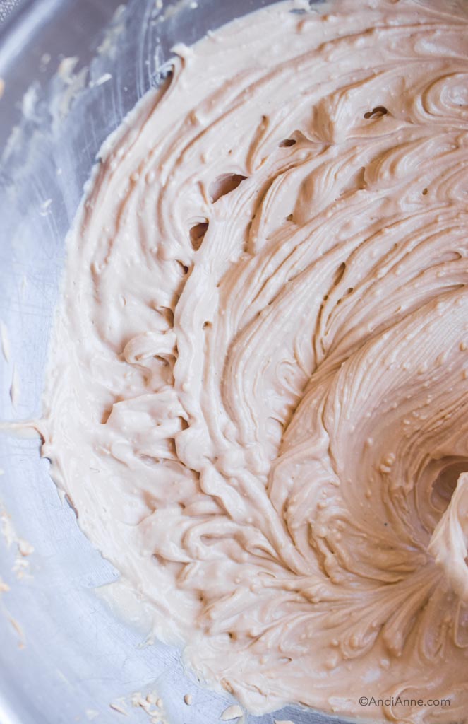 close up of smooth creamy cream cheese frosting in 