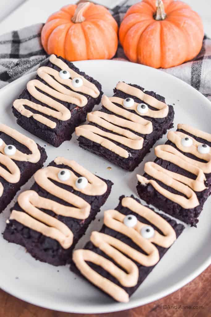 Side angle of the halloween chickpea brownies on a white plate.