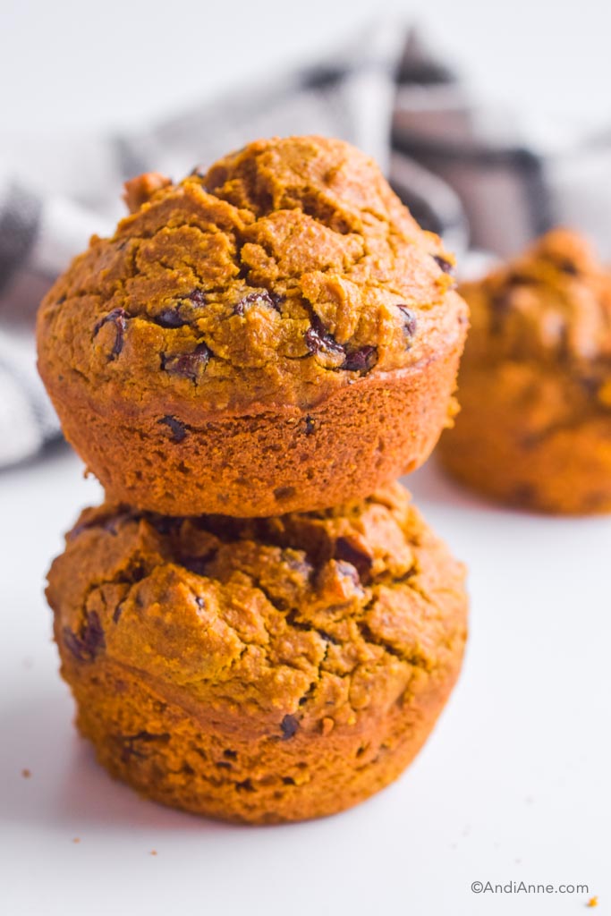 two stacked pumpkin chocolate chip muffins. 