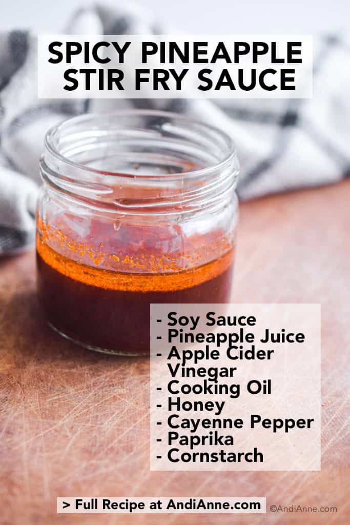 spicy pineapple stir fry sauce in glass jar with kitchen towel behind it
