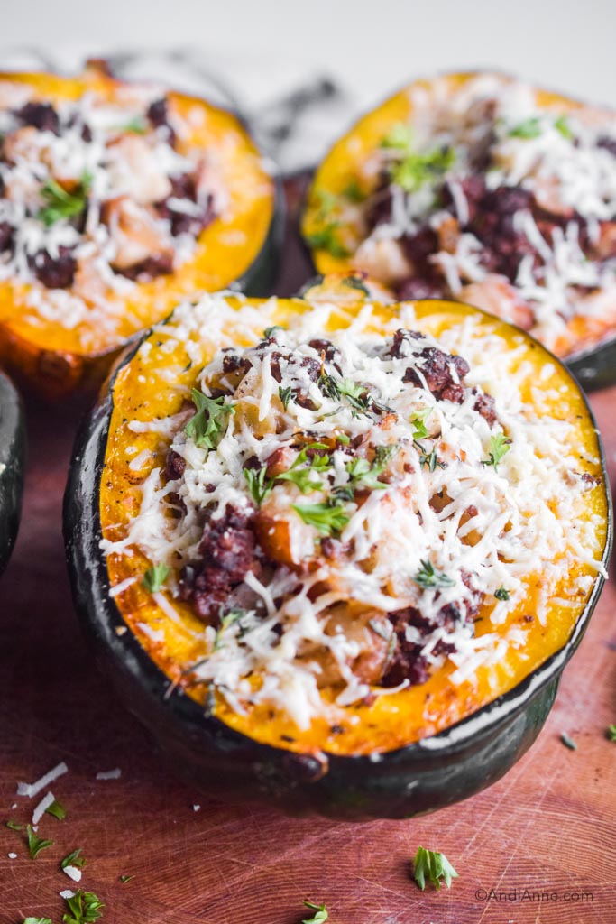 Close up of cooked stuffed acorn squash with grated parmesan on top