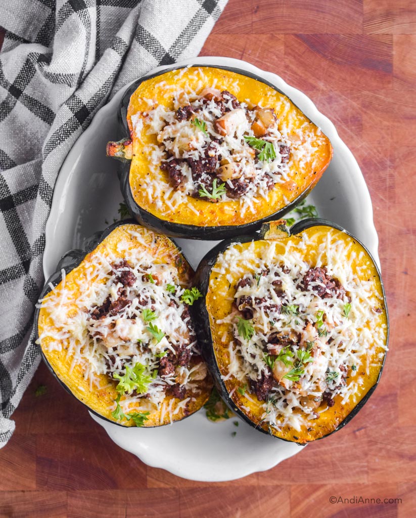 Three slices of stuffed acorn squash on a white plate 