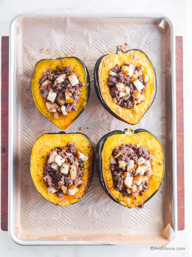 Stuffed acorn squash on a large baking sheet