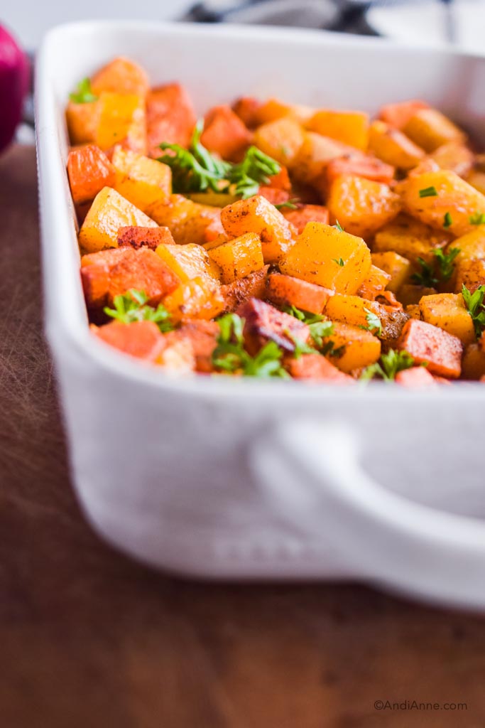 close up of sweet potato and squash cubes in a white dish