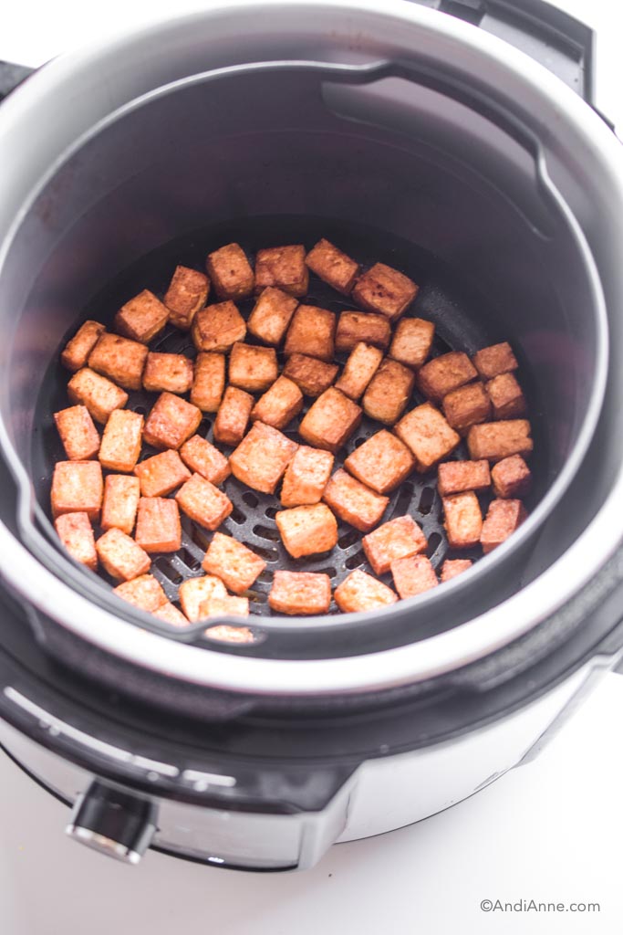looking into air fryer with crispy tofu inside