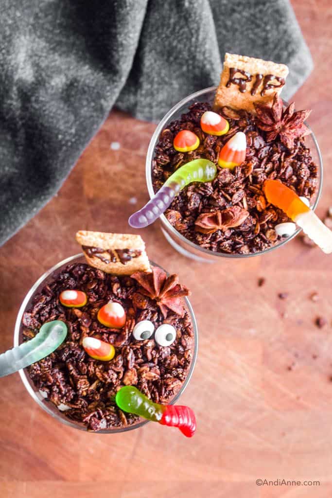 Looking down at the halloween graveyard dirt cups where you can see different types of candies and the chocolate granola base.