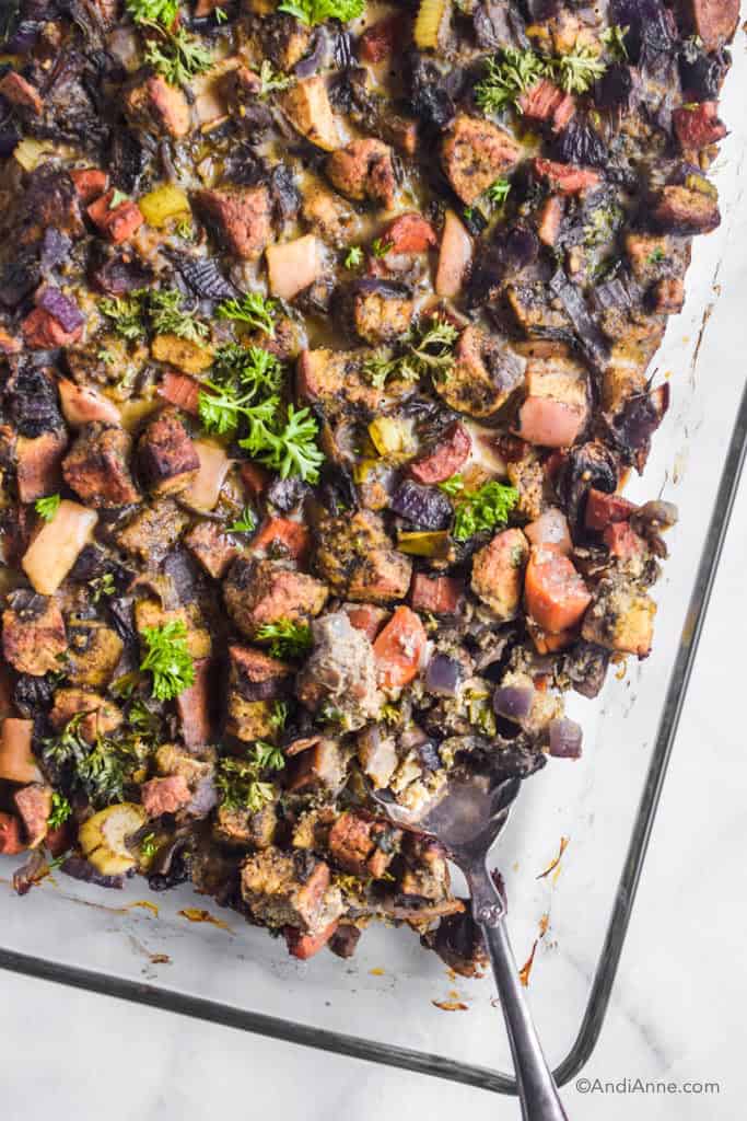 close up of keto stuffing in the casserole dish with silver spoon