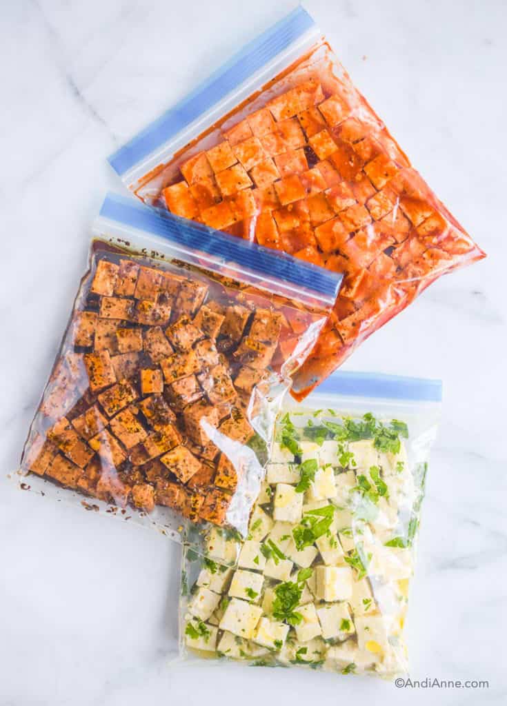 Three tofu marinades in ziploc bags including basil balsamic, cilantro lime and barbecue.