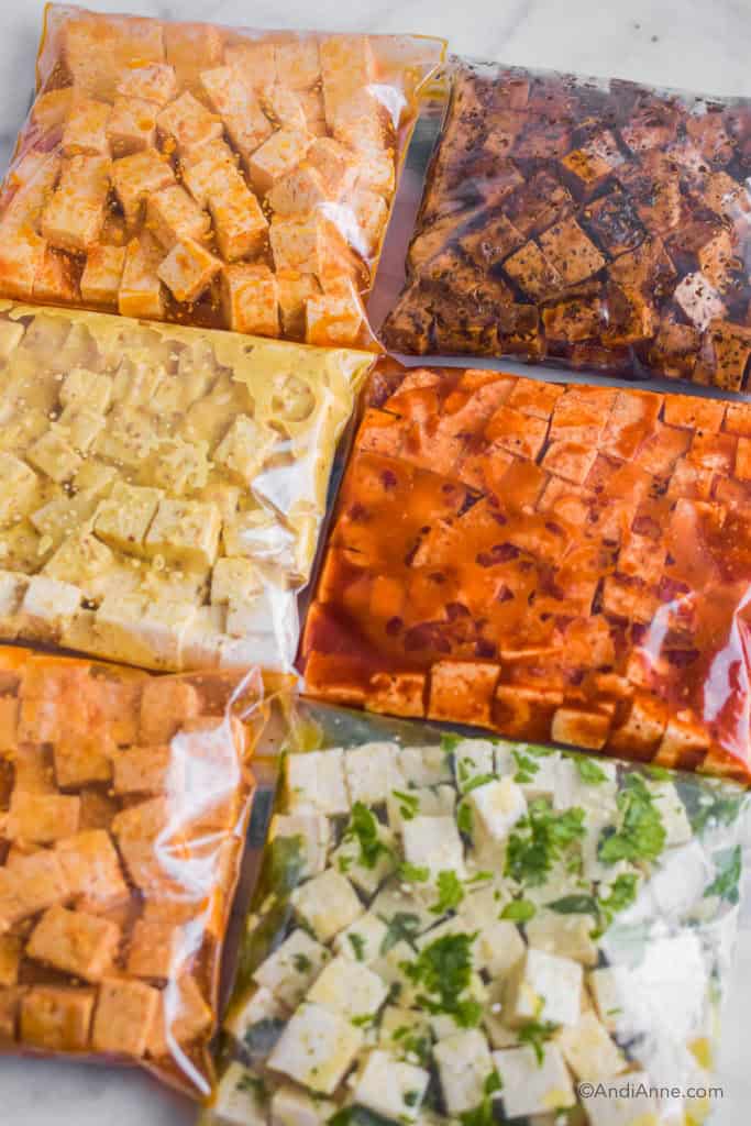 side angle of the chopped tofu and marinade inside ziploc bags.