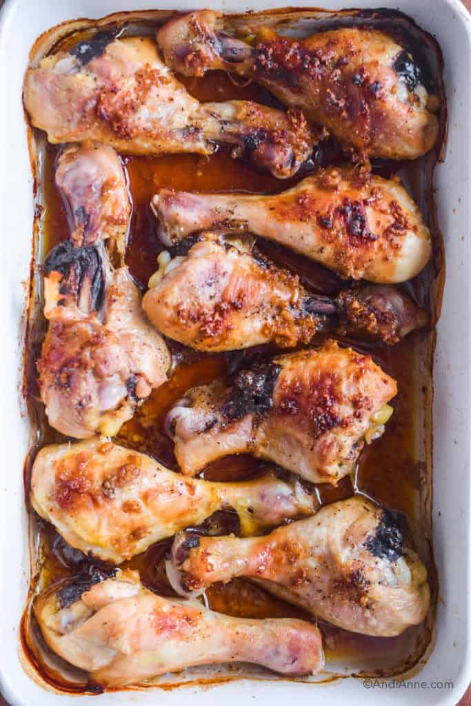 ginger garlic chicken legs in a white baking dish.