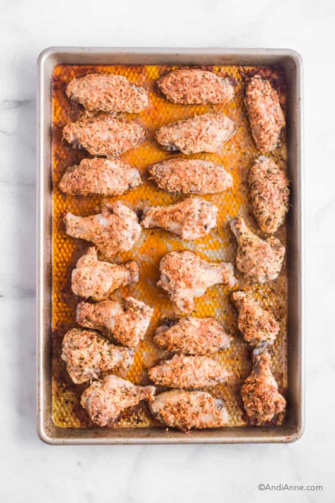 parmesan chicken wings cooked on a baking sheet