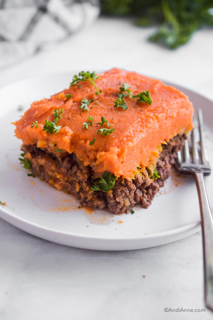 slice of sweet potato shepherds pie on a plate with a fork.
