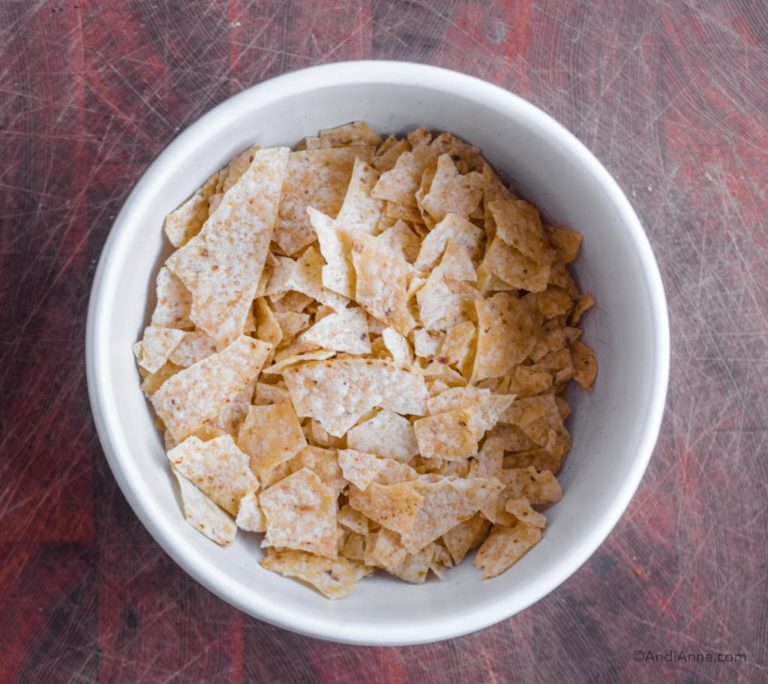 crushed tortilla chips in a white bowl