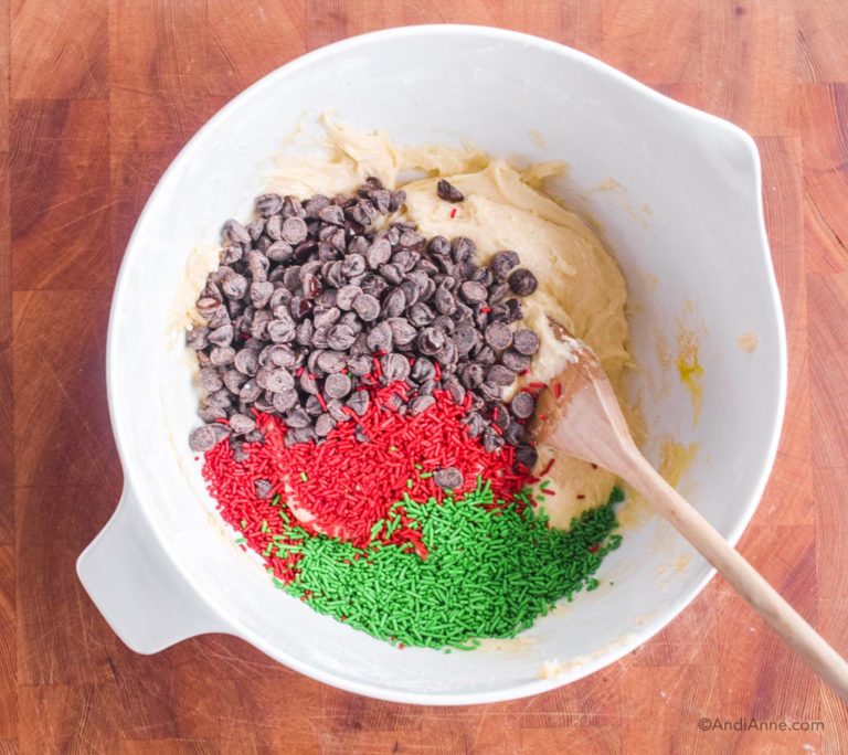 wet batter, chocolate chips, sprinkles and wood spoon in bowl